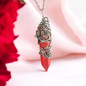 Red stone pendant on silvertone chain